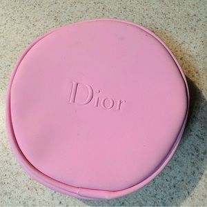 Round Dior makeup bag.
